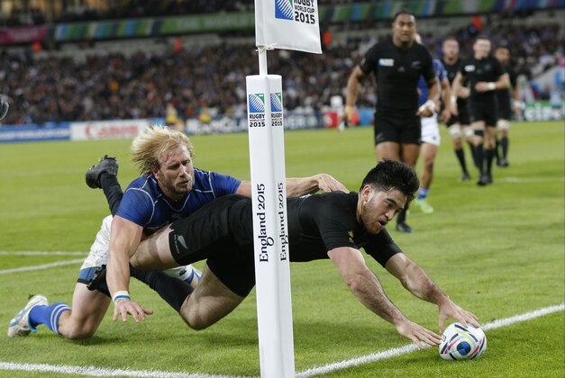 New Zealand's Nehe Milner-Skudder scores a try despite the tackle from Namibia's Conrad Marais during the Rugby World Cup Pool C match between New Zealand and Namibia at the Olympic Stadium, London, Thursday, Sept. 24, 2015. (AP Photo/Christophe Ena)