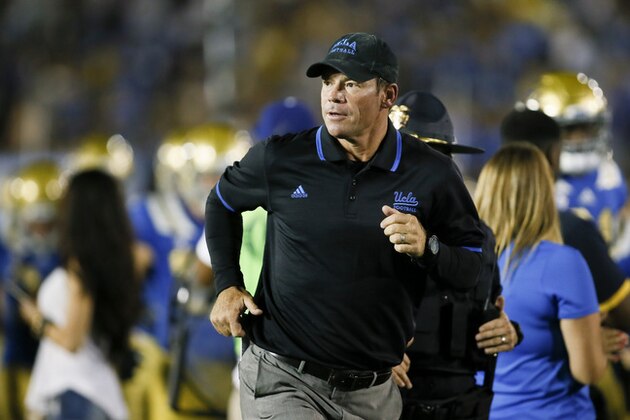 FILE- In this Sept. 19, 2015, file photo, UCLA head coach Jim Mora runs on the fieldduring an NCAA college football game against BYU in Pasadena, Calif. The Bruins are coming off a tough home win against BYU. Add a good road victory to that and they become the early front-runner to snag a playoff bid out of the Pac-12, though injuries are mounting and running through the South unbeaten might be too tough for any team.  (AP Photo/Danny Moloshok, File_