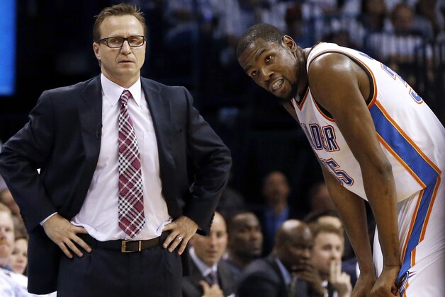 FILE - In this May 31, 2014, file photo, Oklahoma City Thunder coach Scott Brooks, left, and forward Kevin Durant pause during a break against the San Antonio Spurs in the second half of Game 6 of the Western Conference finals NBA basketball playoff series in Oklahoma City. The Thunder fired Brooks on Wednesday, April 22, 2015. (AP Photo/Sue Ogrocki, File)