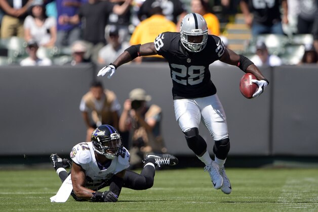 Sep 20, 2015; Oakland, CA, USA; Oakland Raiders running back Latavius Murray (28) is defended by Baltimore Ravens cornerback Jimmy Smith (22) in the first quarter as  at O.co Coliseum. Mandatory Credit: Kirby Lee-USA TODAY Sports