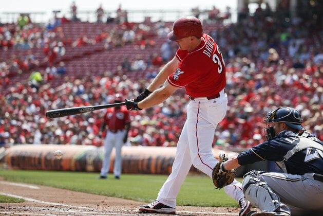 Cincinnati Reds' Jay Bruce hits an infield single to drive in Joey Votto in the first inning of a baseball game against the Milwaukee Brewers, Sunday, Sept. 6, 2015, in Cincinnati. (AP Photo/John Minchillo)