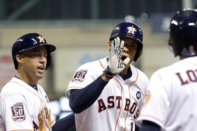 Houston Astros' Carlos Correa (1) celebrates his two-run home run with Jed Lowrie (8) and George Springer, left, during the third inning of a baseball game against the Los Angeles Angels, Monday, Sept. 21, 2015, in Houston. Springer scored on Correa's home run. (AP Photo/David J. Phillip)