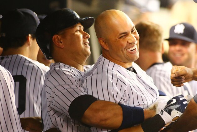 Sep 24, 2015; Bronx, NY, USA; New York Yankees right fielder Carlos Beltran (R) is hugged by designated hitter Alex Rodriguez (13) in the dugout after hitting a three run home run against the Chicago White Sox in the third inning at Yankee Stadium. Mandatory Credit: Andy Marlin-USA TODAY Sports