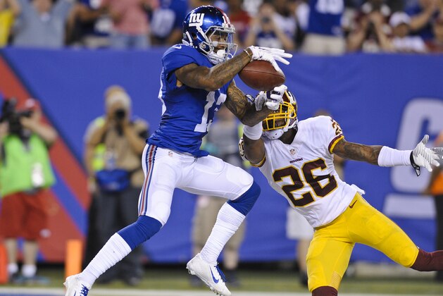 New York Giants wide receiver Odell Beckham (13) catches a pass for a touchdown in front of Washington Redskins' Bashaud Breeland (26) during the second half an NFL football game Thursday, Sept. 24, 2015, in East Rutherford, N.J. (AP Photo/Bill Kostroun)