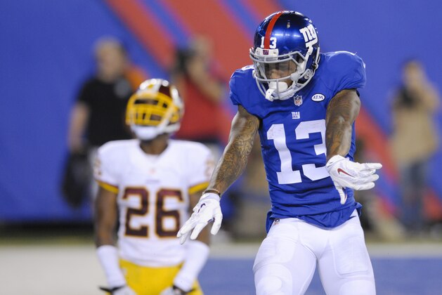 New York Giants wide receiver Odell Beckham (13) celebrates after catching a pass for a touchdown in front of Washington Redskins' Bashaud Breeland (26) during the second half an NFL football game Thursday, Sept. 24, 2015, in East Rutherford, N.J. (AP Photo/Bill Kostroun)