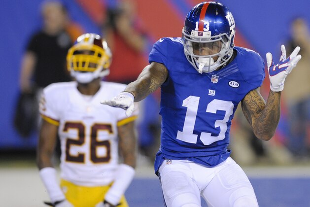New York Giants wide receiver Odell Beckham (13) celebrates after catching a pass for a touchdown in front of Washington Redskins' Bashaud Breeland (26) during the second half an NFL football game Thursday, Sept. 24, 2015, in East Rutherford, N.J. (AP Photo/Bill Kostroun)