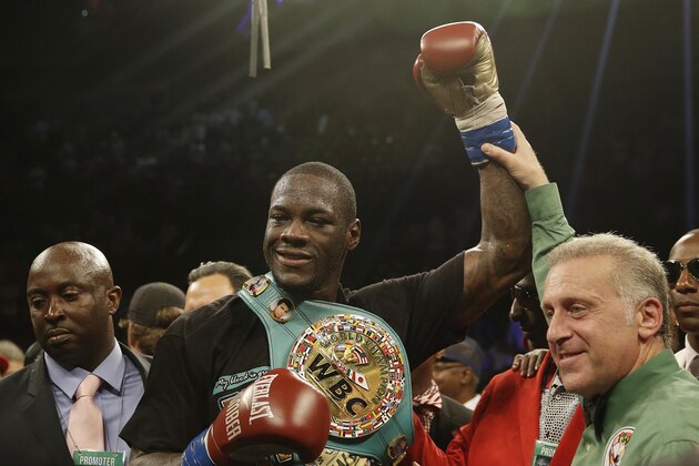 Deontay Wilder holds up his arm after he defeates Eric Molina during the WBC heavyweight boxing match, Saturday, June 13, 2015, in Birmingham, Ala. (AP Photo/Brynn Anderson)