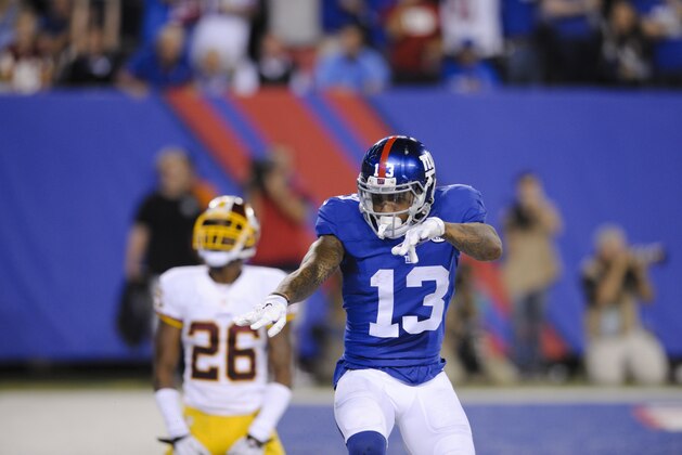 New York Giants wide receiver Odell Beckham (13) celebrates after catching a pass for a touchdown in front of Washington Redskins' Bashaud Breeland (26) during the second half an NFL football game Thursday, Sept. 24, 2015, in East Rutherford, N.J. (AP Photo/Bill Kostroun)
