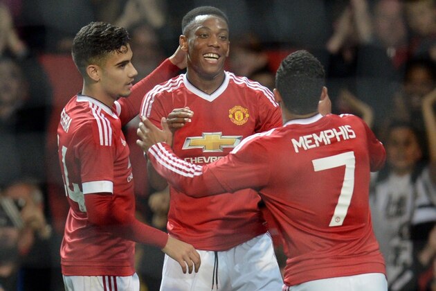 Manchester United's French midfielder Anthony Martial celebrates with Manchester United's Belgian midfielder Andreas Pereira (L) and Manchester United's Dutch midfielder Memphis Depay (R) after scoring their third goal during the English League Cup third round football match between Manchester United and Ipswich Town at Old Trafford in Manchester, north west England on September 23, 2015. Manchester United won the game 3-0. AFP PHOTO / OLI SCARFF

RESTRICTED TO EDITORIAL USE. No use with unauthorized audio, video, data, fixture lists, club/league logos or 'live' services. Online in-match use limited to 75 images, no video emulation. No use in betting, games or single club/league/player publications.        (Photo credit should read OLI SCARFF/AFP/Getty Images)
