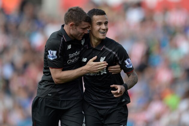 Liverpool's Brazilian midfielder Philippe Coutinho (R) celebrates with Liverpool's English midfielder James Milner after scoring the opening goal of the English Premier League football match between Stoke City and Liverpool at the Britannia Stadium in Stoke-on-Trent, central England on August 9, 2015. AFP PHOTO / OLI SCARFF
RESTRICTED TO EDITORIAL USE. No use with unauthorized audio, video, data, fixture lists, club/league logos or 'live' services. Online in-match use limited to 75 images, no video emulation. No use in betting, games or single club/league/player publications.. (Photo credit should read OLI SCARFF/AFP/Getty Images) Liverpool's Brazilian midfielder Philippe Coutinho (R) celebrates with Liverpool's English midfielder James Milner after scoring the opening goal of the English Premier League football match between Stoke City and Liverpool at the Britannia Stadium in Stoke-on-Trent, central England on August 9, 2015. AFP PHOTO / OLI SCARFF
RESTRICTED TO EDITORIAL USE. No use with unauthorized audio, video, data, fixture lists, club/league logos or 'live' services. Online in-match use limited to 75 images, no video emulation. No use in betting, games or single club/league/player publications.. (Photo credit should read OLI SCARFF/AFP/Getty Images)
