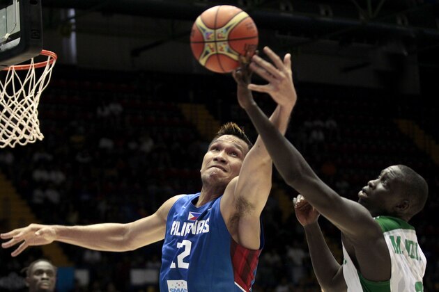 Philippines' June Mar Fajardo, left, vies with Senegal's Maleye Ndoye, right, during the Group B Basketball World Cup match in Seville, Spain, Thursday, Sept. 4, 2014. The 2014 Basketball World Cup competition will take place in various cities in Spain from Aug. 30 through to Sept. 14. (AP Photo/Miguel Angel Morenatti)
