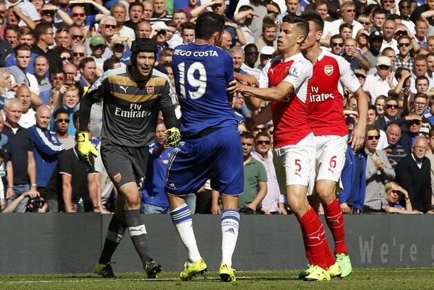 Arsenal's Gabriel, No 5, reacts and puts his arms onto Chelsea's Diego Costa, No 19, during the English Premier League soccer match between Chelsea and Arsenal at Stamford Bridge stadium in London, Saturday, Sept. 19, 2015. Both players were show a yellow card for the incident, with Gabriel being sent off for a further clash between the two player- Chelsea went onto win the game 2-0.(AP Photo/Alastair Grant)