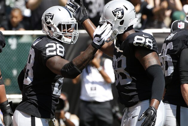 Oakland Raiders' Latavius Murray (28) celebrates his touchdown with teammate Clive Walford (88) during the first half of an NFL football game Sunday, Sept. 20, 2015, in Oakland , Calif. (AP Photo/Tony Avelar)