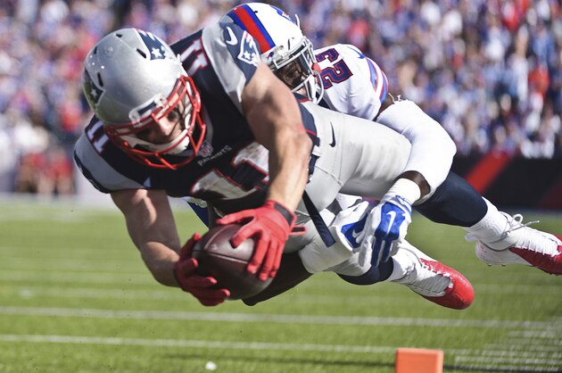 New England Patriots wide receiver Julian Edelman (11) dives past Buffalo Bills free safety Aaron Williams (23) for a touchdown during the second half of an NFL football game Sunday, Sept. 20, 2015, in Orchard Park, N.Y. (AP Photo/Gary Wiepert)