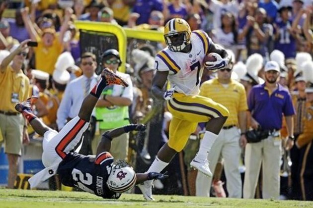 FILE - In this Sept. 19, 2015, file photo, LSU running back Leonard Fournette (7) gets away from Auburn defensive back Blake Countess (24) on a 40-yard touchdown run durin an NCAA college football game in Baton Rouge, La. No. 8 LSU is heading North to take on Syracuse in the Carrier Dome. It is the first time the Tigers will play in New York state since they beat Fordham at the Polo Grounds in 1942. (AP Photo/Gerald Herbert, File)