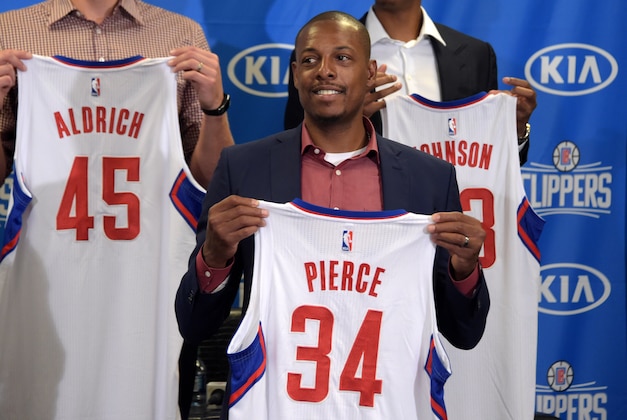 Jul 21, 2015; Los Angeles, CA, USA; Los Angeles Clippers players Cole Aldrich (45), Paul Pierce (34) and Wesley Johnson (33) pose with jerseys at press conference at Staples Center. Mandatory Credit: Kirby Lee-USA TODAY Sports