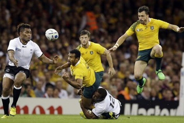 Fiji's Gabiriele Lovobalavu tackles Australia's Will Genia during the Rugby World Cup Pool A match between Australia and Fiji at the Millennium Stadium, Cardiff,  Wednesday, Sept. 23, 2015. (AP Photo/Matt Dunham)