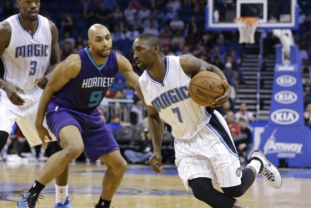 Orlando Magic's Ben Gordon (7) drives around Charlotte Hornets' Gerald Henderson (9) during the second half of an NBA basketball game, Sunday, March 1, 2015, in Orlando, Fla. Charlotte won 98-83. (AP Photo/John Raoux)