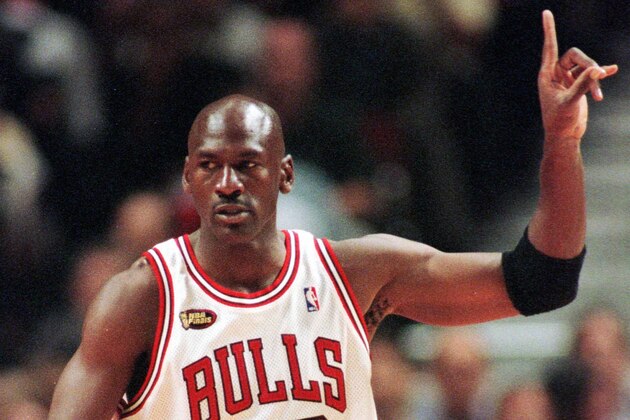 Chicago Bulls guard Michael Jordan signals to his teammates during the first quarter of Game 5 of the NBA finals in Chicago, Friday, June 12, 1998. (AP Photo/Beth A. Keiser)