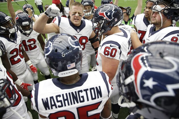 Players huddle around Houston Texans defensive end J.J. Watt (99)  before an NFL football game Sunday, Sept. 13, 2015, in Houston. (AP Photo/David J. Phillip)