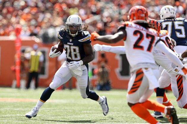 CINCINNATI, OH - SEPTEMBER 20:  Melvin Gordon #28 of the San Diego Chargers attempts to run past Carlos Dunlap #96  and Dre Kirkpatrick #27, both of the Cincinnati Bengals, during the first quarter at Paul Brown Stadium on September 20, 2015 in Cincinnati, Ohio. (Photo by Andy Lyons/Getty Images)