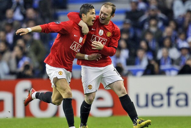 Manchester United's Cristiano Ronaldo, left,  celebrates with Wayne Rooney after scoring the opening goal against FC Porto during their Champions League quarter final second leg, soccer match Wednesday, April 15 2009, at the Dragao stadium in Porto, northern Portugal. (AP Photo / Armando Franca)