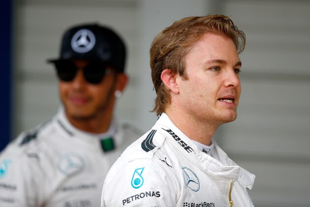 SUZUKA, JAPAN - SEPTEMBER 26:  Nico Rosberg of Germany and Mercedes GP looks on next to Lewis Hamilton of Great Britain and Mercedes GP in Parc Ferme after claiming pole position during qualifying for the Formula One Grand Prix of Japan at Suzuka Circuit on September 26, 2015 in Suzuka.  (Photo by Clive Rose/Getty Images)