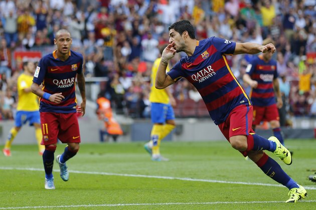 FC Barcelona's Luis Suarez, right, reacts after scoring during a Spanish La Liga soccer match against Las Palmas at the Camp Nou stadium in Barcelona, Spain, Saturday, Sept. 26, 2015. (AP Photo/Manu Fernandez)