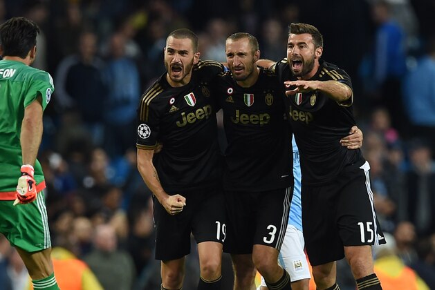 (L-R) Juventus' goalkeeper from Italy Gianluigi Buffon, Juventus' defender from Italy Leonardo Bonucci, Juventus' defender from Italy Giorgio Chiellini and Juventus' defender from Italy Andrea Barzagli celebrate after winning a UEFA Champions League group stage football match between Manchester City and Juventus at the Etihad stadium in Manchester, north-west England on September 15, 2015.   AFP PHOTO / PAUL ELLIS        (Photo credit should read PAUL ELLIS/AFP/Getty Images)