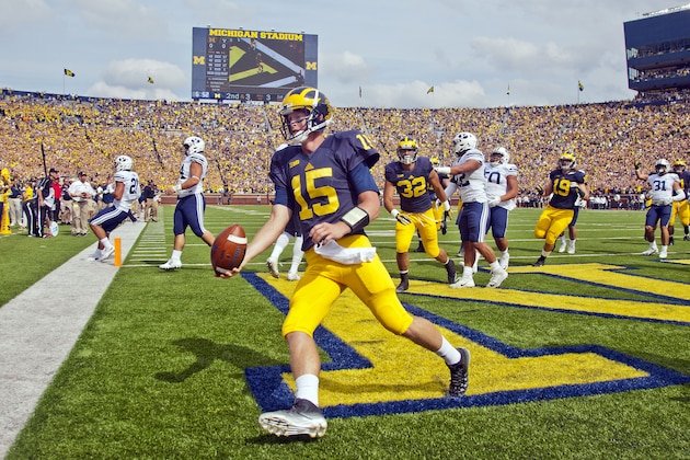 Michigan quarterback Jake Rudock (15) celebrates his touchdown in the first quarter of an NCAA college football game against BYU in Ann Arbor, Mich., Saturday, Sept. 26, 2015. (AP Photo/Tony Ding)