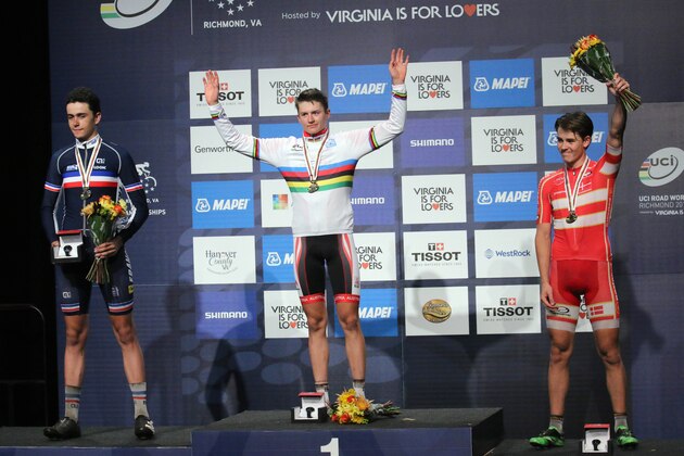 Silver-medalist Clement Betouigt-Suire, left, of France, gold-medalist Felix Gall, center, of Austria, and bronze medalist Rasmus Pedersen, of Denmark, react during the medal ceremony for the Men's Junior Road Circuit cycling race at the UCI Road World Championships in Richmond, Va., Saturday, Sept. 26, 2015. (AP Photo/Skip Rowland)