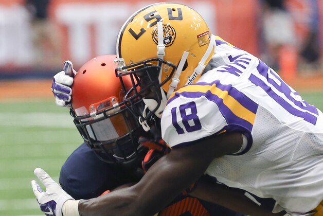 Syracuse wide receiver Steve Ishmael (8) is tackled by LSU cornerback Tre'Davious White (18) during the second half of an NCAA college football game on Saturday, Sept. 26, 2015, in Syracuse, N.Y. (AP Photo/Mike Groll)
