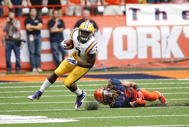 LSU running back Leonard Fournette (7) gets past Syracuse safety Rodney Williams (6) during the first half of an NCAA college football game on Saturday, Sept. 26, 2015, in Syracuse, N.Y. (AP Photo/Mike Groll)