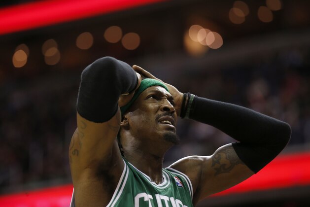 Boston Celtics forward Gerald Wallace (45) reacts after a hard contact with Washington Wizards center Marcin Gortat, from Poland in the second half of an NBA basketball game, Wednesday, Jan. 22, 2014, in Washington. The Celtics won 113-111, in overtime. (AP Photo/Alex Brandon)