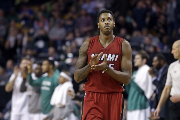 Miami Heat guard Mario Chalmers (15) claps as during a timeout in the second half of an NBA basketball game against the Boston Celtics in Boston, Wednesday, March 25, 2015. The Heat won 93-86. (AP Photo/Elise Amendola)