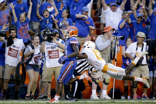 Florida wide receiver Antonio Callaway , left, crosses the goal line past Tennessee defensive back Malik Foreman, right, to score the game winning touchdown on a 63-yard pass play during the final minutes  of an NCAA college football game, Saturday, Sept. 26, 2015, in Gainesville, Fla. Florida won 28-27. (AP Photo/John Raoux)