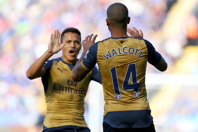 Arsenals English striker Theo Walcott (R) celebrates with Arsenal's Chilean striker Alexis Sanchez after Walcott socred his team's opening goal during the English Premier League football match between Leicester City and Arsenal at King Power Stadium in Leicester, central England, on September 26, 2015.  AFP PHOTO / GEOFF CADDICK

RESTRICTED TO EDITORIAL USE. No use with unauthorized audio, video, data, fixture lists, club/league logos or 'live' services. Online in-match use limited to 75 images, no video emulation. No use in betting, games or single club/league/player publications.        (Photo credit should read GEOFF CADDICK/AFP/Getty Images)
