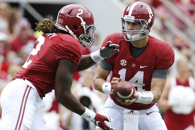 Alabama quarterback Jake Coker (14) hands the ball to running back Derrick Henry (2) during the first half of an NCAA college football game against Louisiana Monroe in Tuscaloosa, Ala., Saturday, Sept. 26, 2015. (AP Photo/Jonathan Bachman)