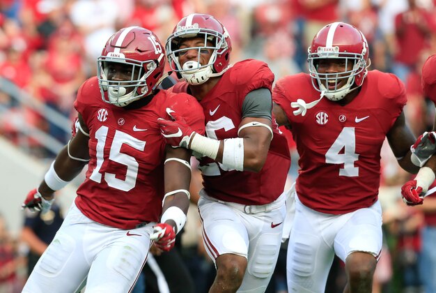 Sep 26, 2015; Tuscaloosa, AL, USA; Alabama Crimson Tide defensive back Ronnie Harrison (15) celebrates with  defensive back Marlon Humphrey (26) after an interception by Harrison against the Louisiana Monroe Warhawks at Bryant-Denny Stadium. The Tide defeated the Warhawks 34-0. Mandatory Credit: Marvin Gentry-USA TODAY Sports
