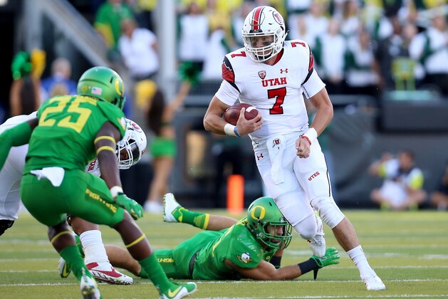 Utah quarterback Travis Wilson (7) runs with the ball during the first half of an NCAA college football game against Oregon, Saturday, Sept. 26, 2015, in Eugene, Ore. (AP Photo/Ryan Kang)