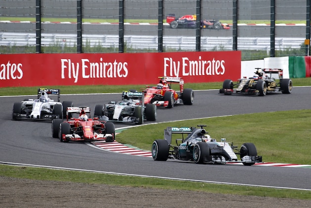 Mercedes driver Lewis Hamilton, right, of Britain leads the field at the first lap of the Japanese Formula One Grand Prix at the Suzuka Circuit in Suzuka, central Japan, Sunday, Sept. 27, 2015. (AP Photo/Toru Takahashi)