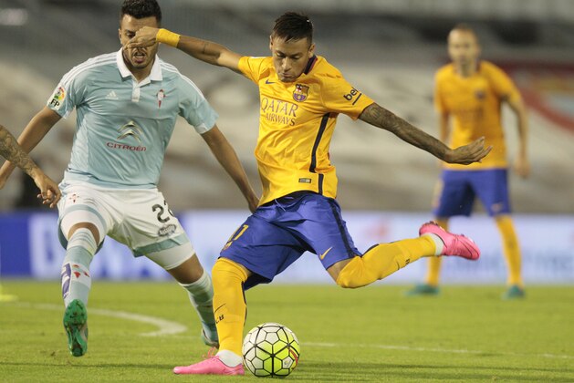 Barcelona's Neymar from Brazil, kicks the ball next to RC Celta’s Gustavo Cabral from Argentina, during a Spanish La Liga soccer match between RC Celta and FC Barcelona, at the Balaídos stadium in Vigo, Spain, Wednesday, Sept. 23, 2015. (AP Photo/Lalo R. Villar)