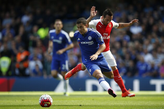 Chelsea's Eden Hazard, let gets past a tackle by Arsenal's Santi Cazorla during the English Premier League soccer match between Chelsea and Arsenal at Stamford Bridge stadium in London, Saturday, Sept. 19, 2015. Chelsea won the game 2-0. (AP Photo/Alastair Grant)