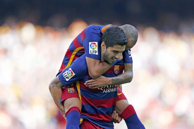 FC Barcelona's Luis Suarez, from Uruguay, bottom, reacts after scoring with his teammate Neymar, from Brazil, during a Spanish La Liga soccer match against Las Palmas at the Camp Nou stadium in Barcelona, Spain, Saturday, Sept. 26, 2015. (AP Photo/Manu Fernandez)