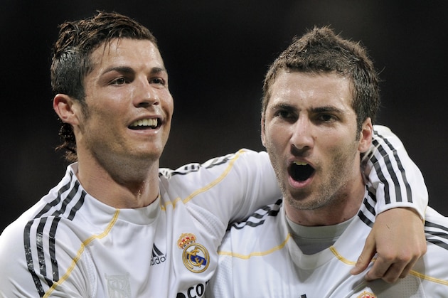 Real Madrid's Gonzalo Higuain from Argentina, right, celebrates with team mate Cristiano Ronaldo from Portugal after scoring a goal against Sporting de Gijon during his La Liga soccer match at the Santiago Bernabeu stadium in Madrid, Saturday, March 20, 2010.(AP Photo/Daniel Ochoa de Olza)