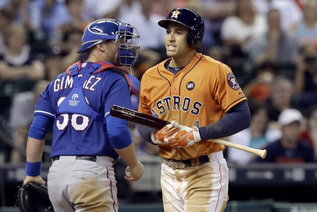 Houston Astros' George Springer (4) reacts after striking out to end the sixth inning as Texas Rangers catcher Chris Gimenez heads to the dugout in a baseball game Friday, Sept. 25, 2015, in Houston. (AP Photo/Pat Sullivan)