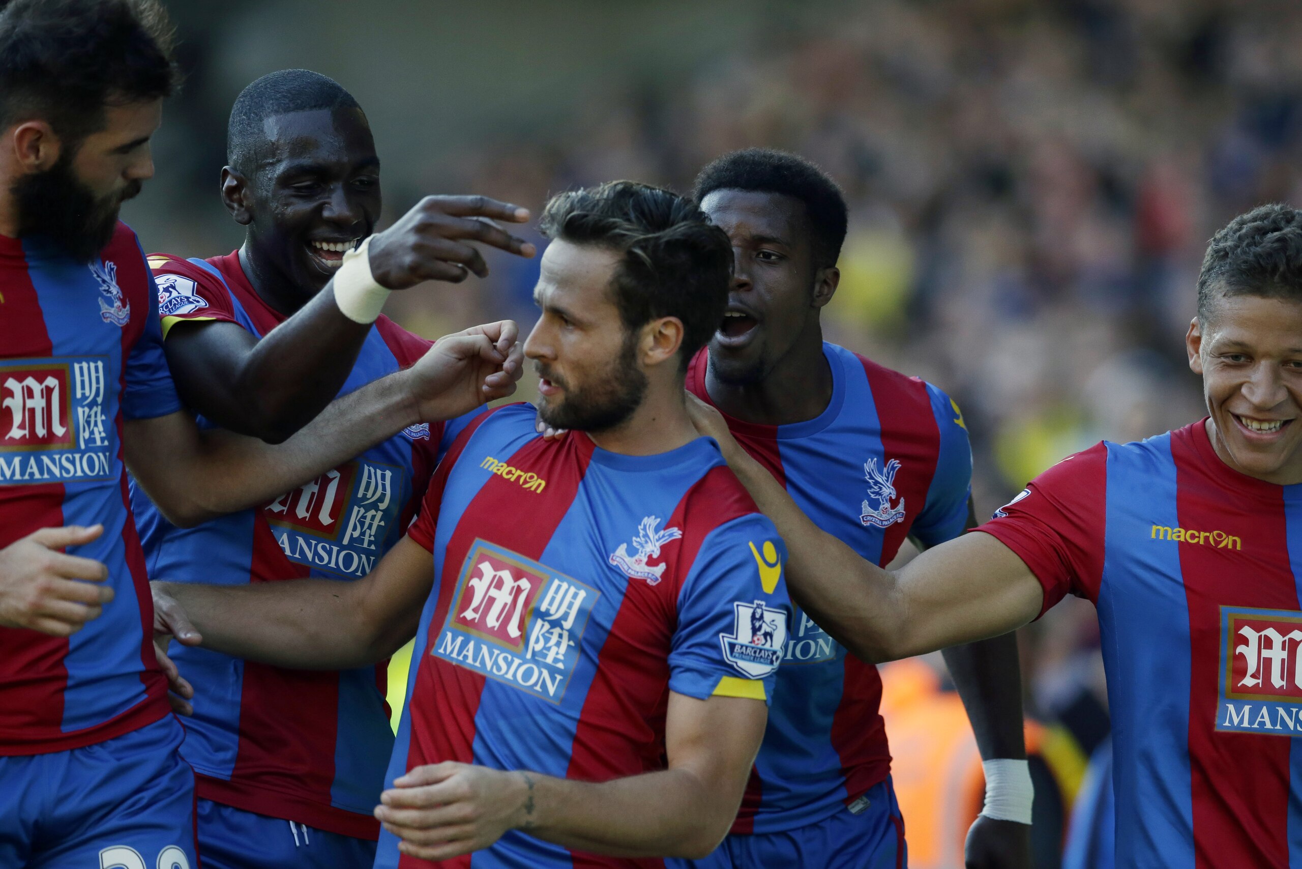 Crystal Palace's Yohan Cabaye, center, celebrates with his teammates, from left, Joe Ledley, Yannick Bolasie, Wilfried Zaha and Dwight Gayle after scoring his side's first goal from a penalty during the English Premier League soccer match between Watford and Crystal Palace at Vicarage Road stadium in London, Sunday, Sept. 27, 2015.  (AP Photo/Matt Dunham)