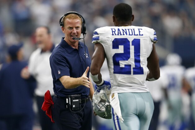 Dallas Cowboys head coach Jason Garrett greets running back Joseph Randle (21) after Randle scored a touchdown in the first half of an NFL football game against the Atlanta Falcons on Sunday, Sept. 27, 2015, in Arlington, Texas. (AP Photo/Brandon Wade)