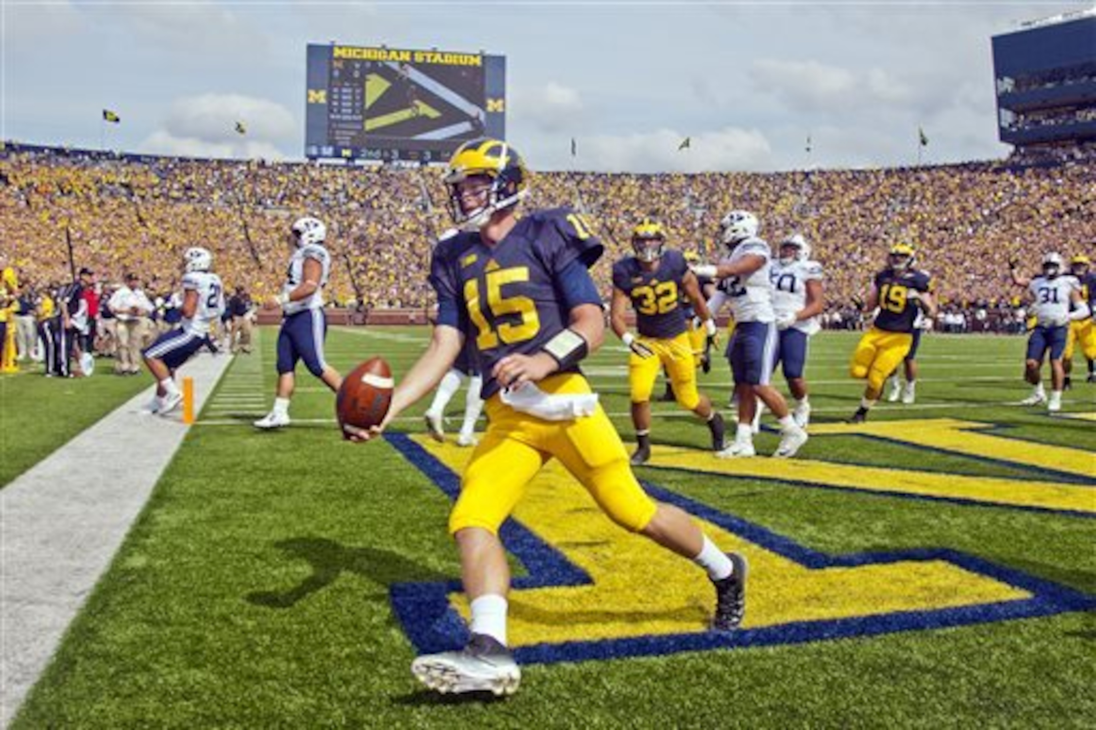 Michigan quarterback Jake Rudock (15) celebrates his touchdown in the first quarter of an NCAA college football game against BYU in Ann Arbor, Mich., Saturday, Sept. 26, 2015. (AP Photo/Tony Ding)