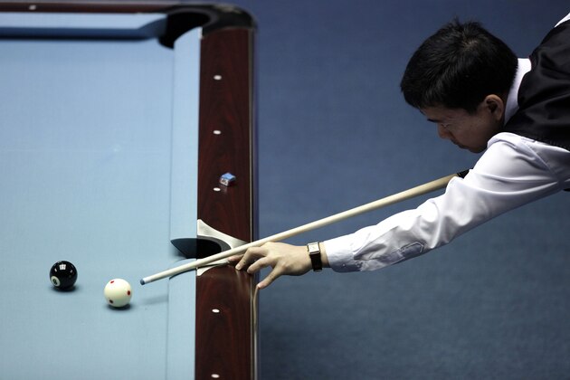Philippine's Warren Kiamco plays against Taiwan's Ko Pin Yi, unseen, during a semi-final match for the men's 9-ball pool singles at the 16th Asian Games in Guangzhou, China, Thursday, Nov. 18, 2010. Kiamco won 9-7. (AP Photo/Ng Han Guan)